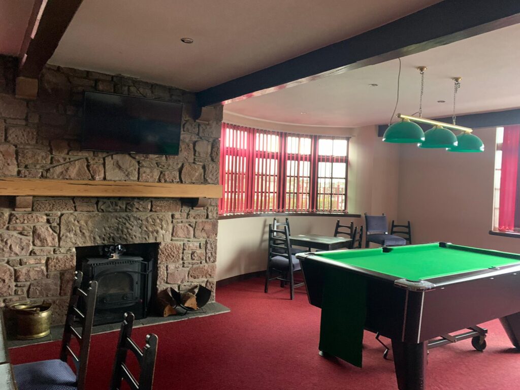 The games room at The Portcullis with pool tables and dart boards